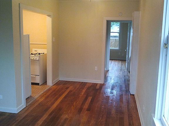 View of dining area through hallway and bedroom