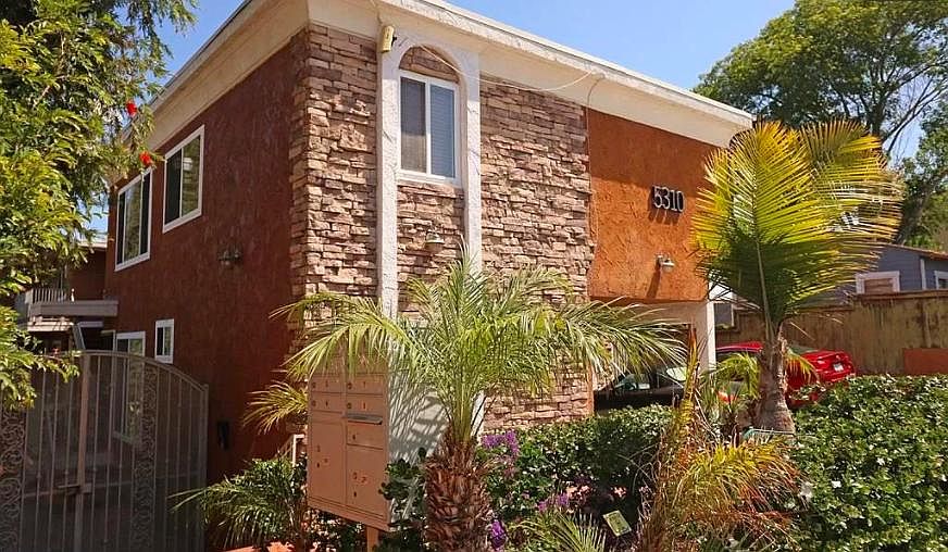 Street View in front of the building. Mailboxes behind first palm tree.