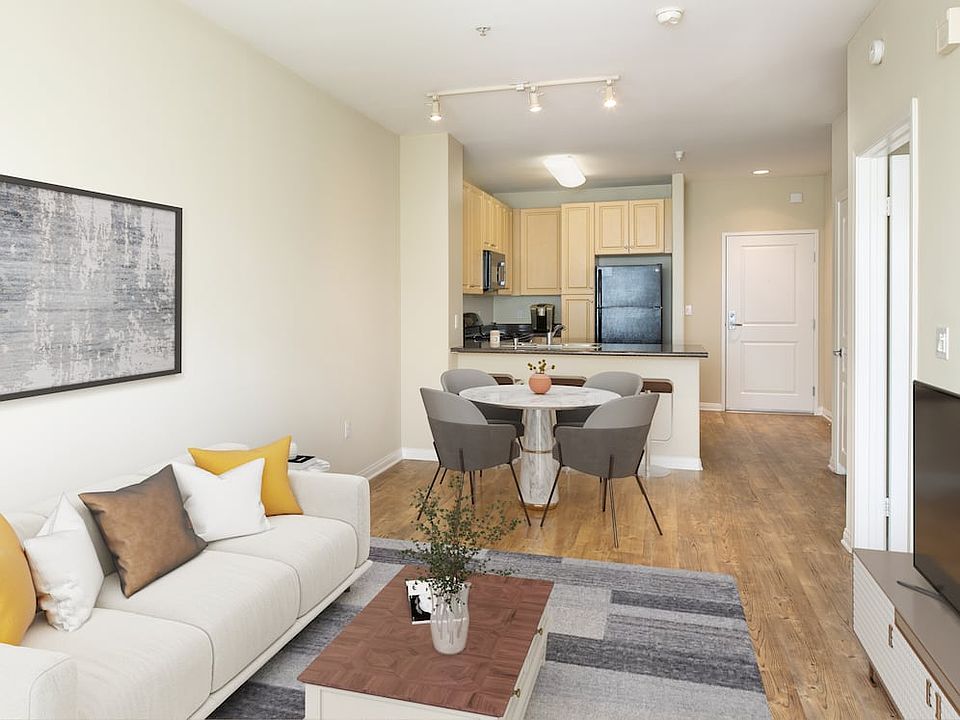 Kitchen, living, and dining areas with hard surface flooring throughout