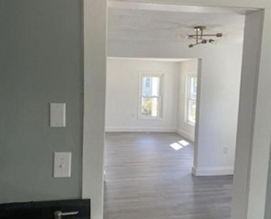 View from the kitchen into the dining room and into the bright living room space.