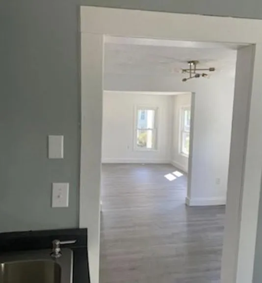 View from the kitchen into the dining room and into the bright living room space.