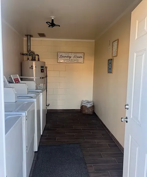 The laundry room is centrally located among the units and has both coin/card operated washers and dryers.