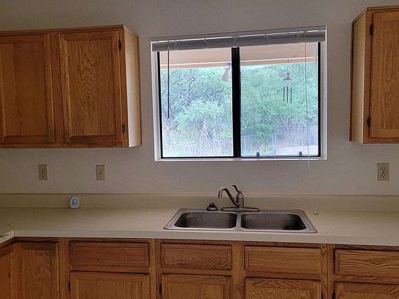 Lots of kitchen cabinets with window view
