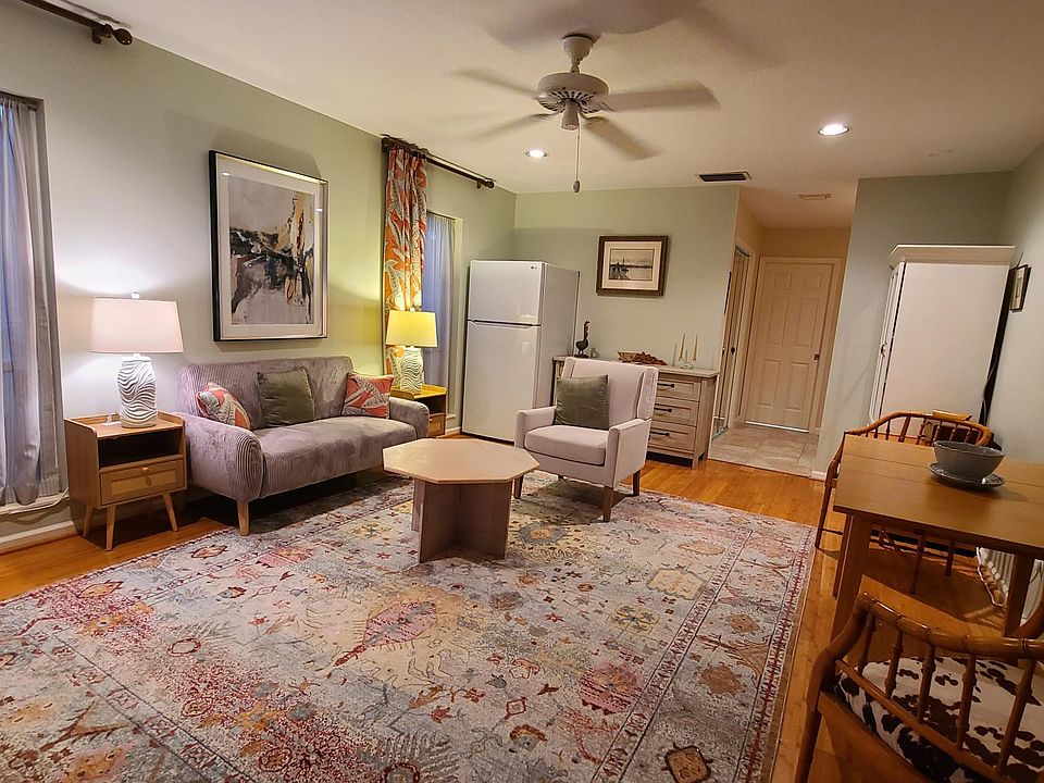 Spacious living/dining, floor-to-ceiling windows, office storage.