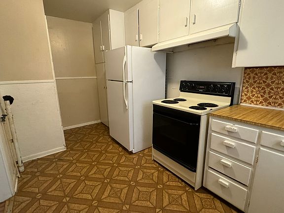 Kitchen with stove and refrigerator