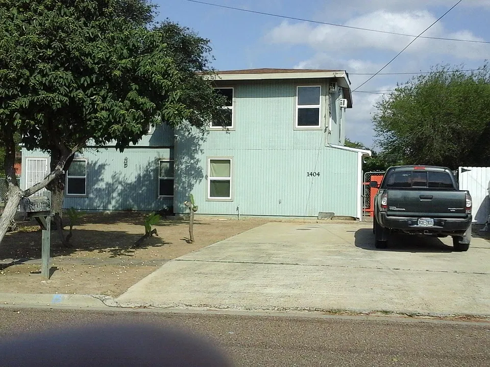 Front view of apartment. Note parking area, front space.