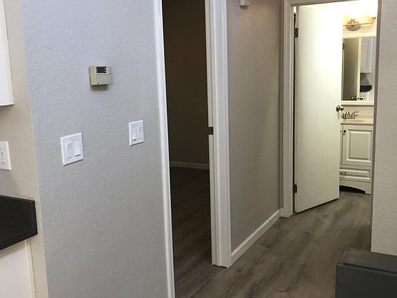 Hallway with bedroom off to left and bathroom ahead