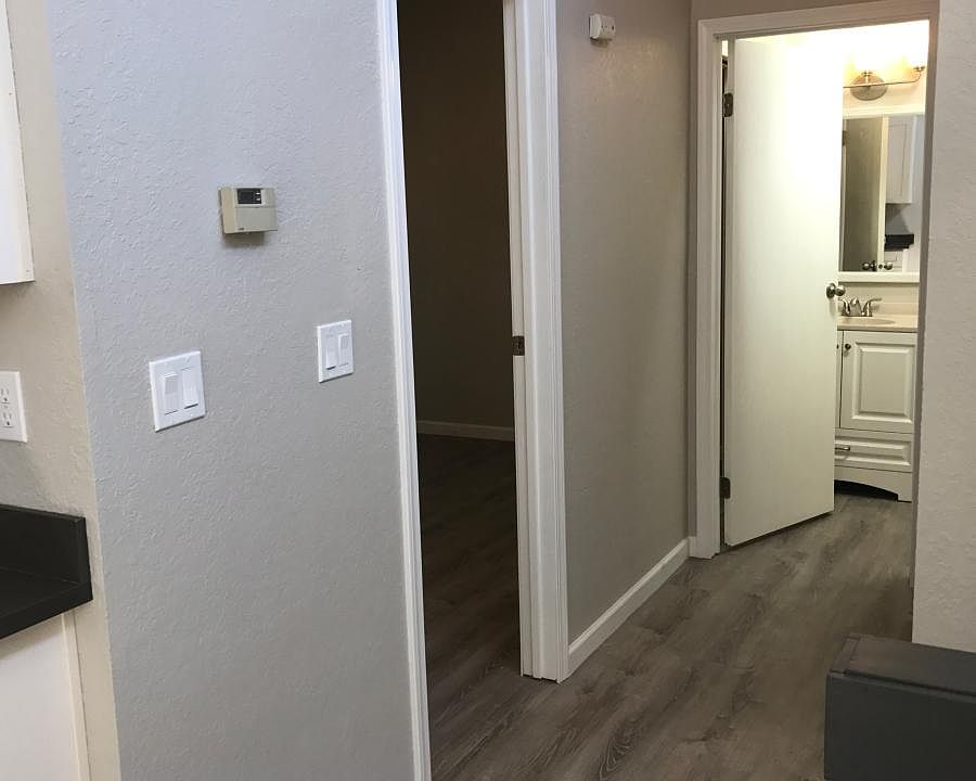 Hallway with bedroom off to left and bathroom ahead
