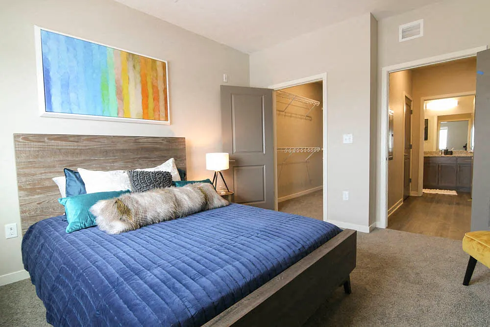 Our bedrooms offer large windows, allowing plenty of natural light and a cozy, comfortable retreat. - WH Flats