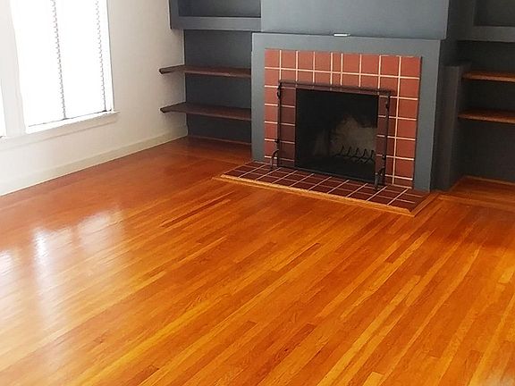 living room - in front of building. Large, good looking, sunny, spacious. Fireplace is not functional.