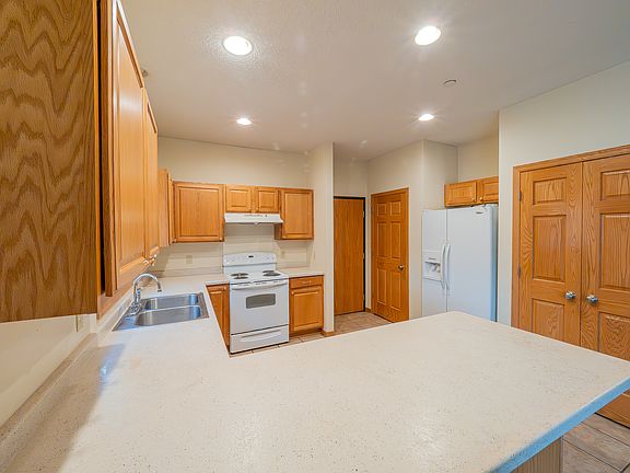 Kitchen includes sink disposal, large fridge, dishwasher, self-cleaning oven, coat closet, and pantry
