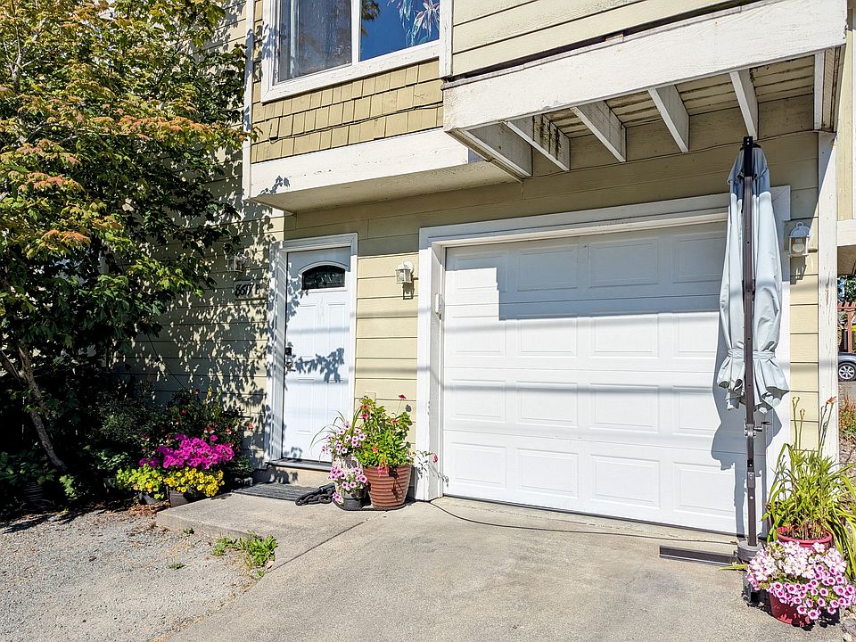 8617 Unit B with paved driveway, 1 car garage, and room for 1-2 cars in front of the house
