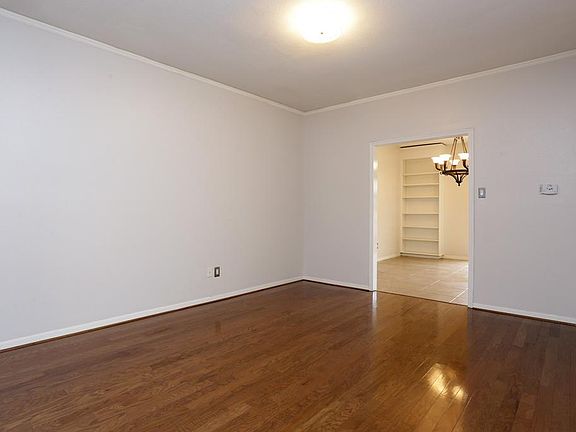 Shot of living/dining combination facing entry to den.