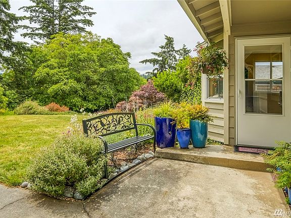 The welcoming front porch with its bench and lovely planters. 