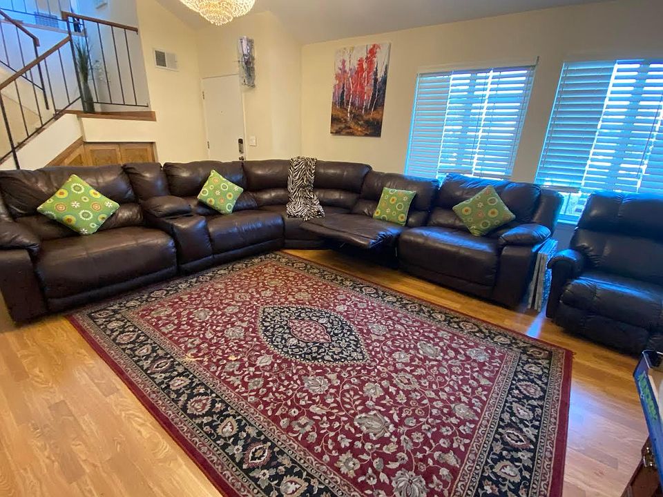 Formal living room with chandelier, sofa with recliners for all which transforms to a bed