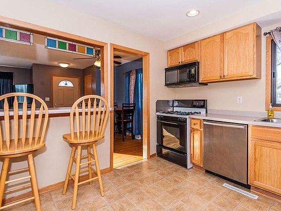 Kitchen with microwave and gas stove.