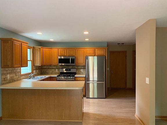 Kitchen with new stainless appliances and nice bar for entertaining.