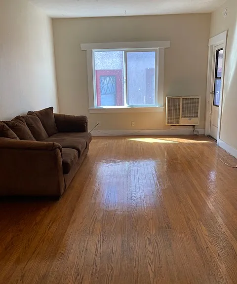 spacious living room with a lot of light from the window.