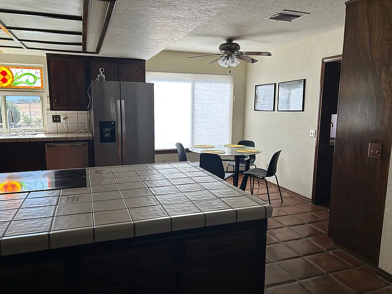 New refrigerator & dishwasher with table for four.