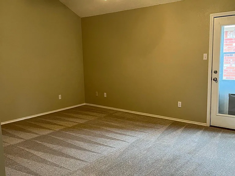 Master bedroom with door to private fenced in yard