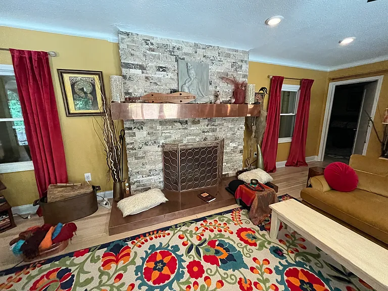 Main living room with wood burning fireplace