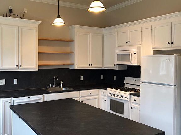 Full size kitchen with gas range/oven, dishwasher, microwave, refrigerator, and tons of cabinet storage and working surfaces. You'll love the kitchen island for gatherings or just being able to spread out your kitchen tasks.