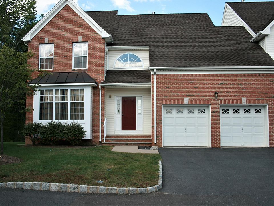 Brick Front with huge Box window and Two Attached Car Garage