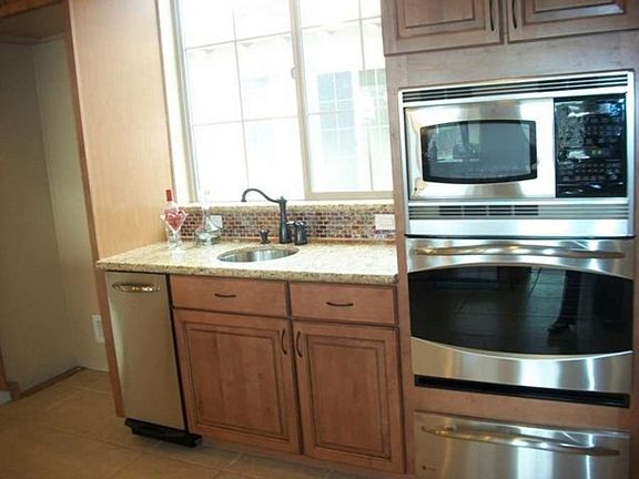 "Wet bar with trash compactor, brand new stainless steel GE Profile appliances"