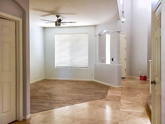 Entry way living room. Half bathroom on left. Storage closet on right. High ceiling foyer entry.