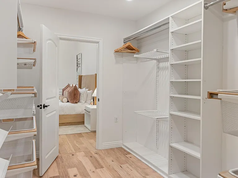 Step into a walk-in closet exuding chic elegance, providing a stylish haven for your wardrobe.