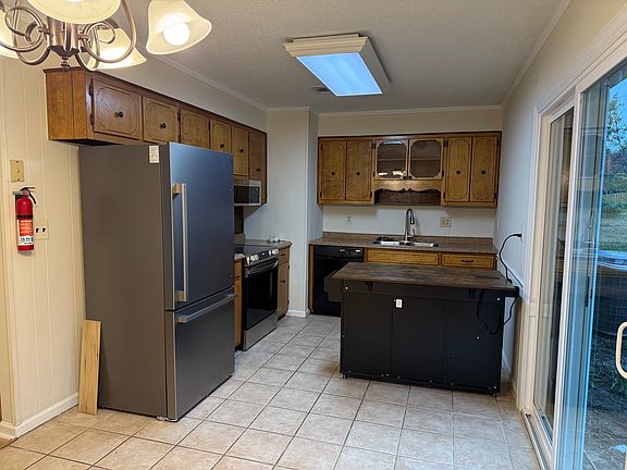 Kitchen updated with new appliances. Stove, microwave, refrigerator with ice maker and dishwasher.