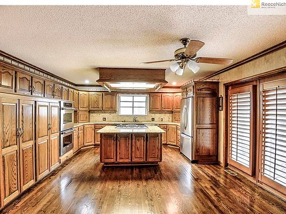 The kitchen is spacious and offers gleaming rich hardwood floors and an abundance of cabinetry and c