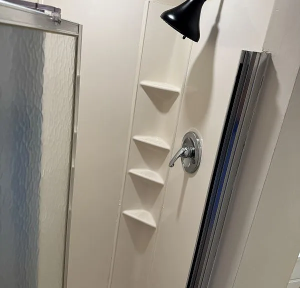 Basement bath has small clean shower.