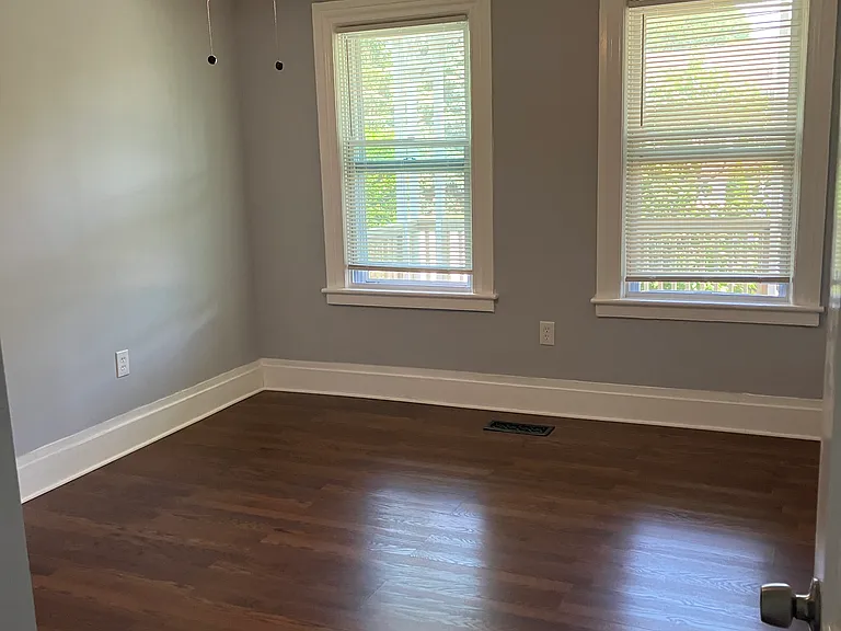 Master bedroom with double windows.