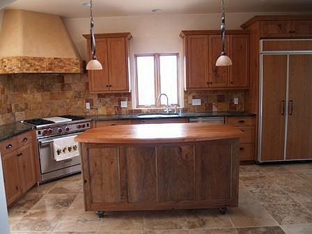 Custom cherry cabinets, granite tops, travertine backsplash