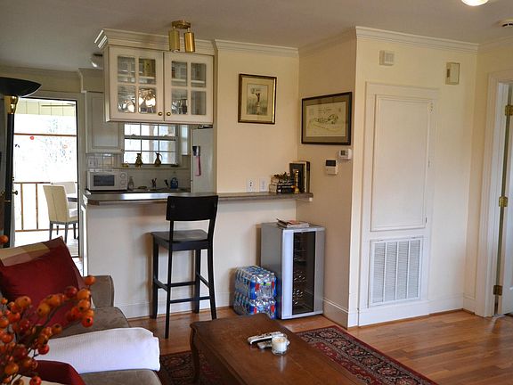 Living room looking into kitchen and out to porch