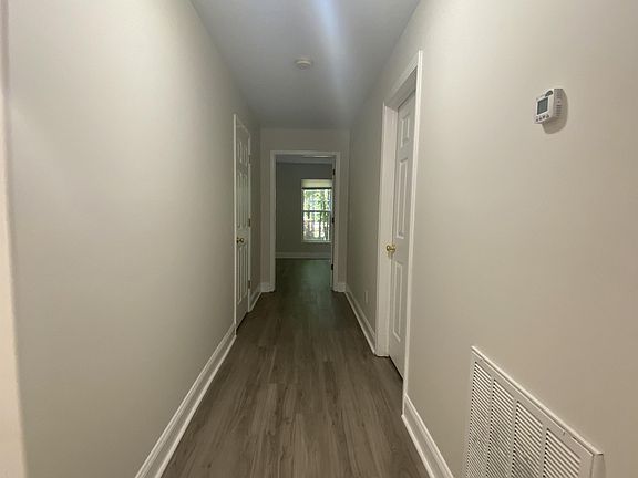 The hallway leads to the utility room and main bedroom.