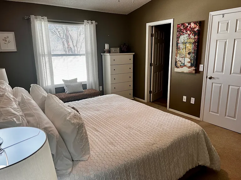 Primary bedroom with king bed and ensuite bathroom.