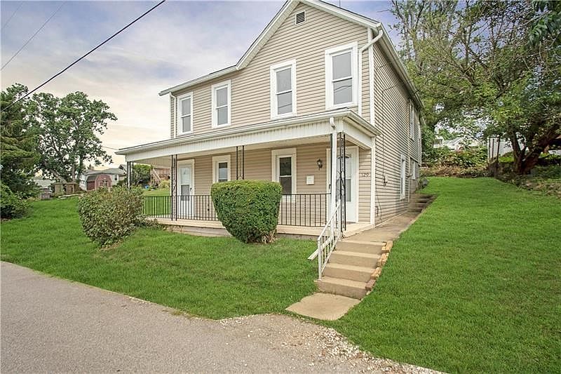 EXTERIOR FRONT - Welcome to 129 Bluff Street.  Attractive vinyl siding with covered front porch and view of side yard.
