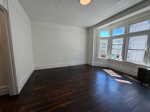 View from kitchen across living room. Front door is to the left of that doorway opening. Bathroom too.