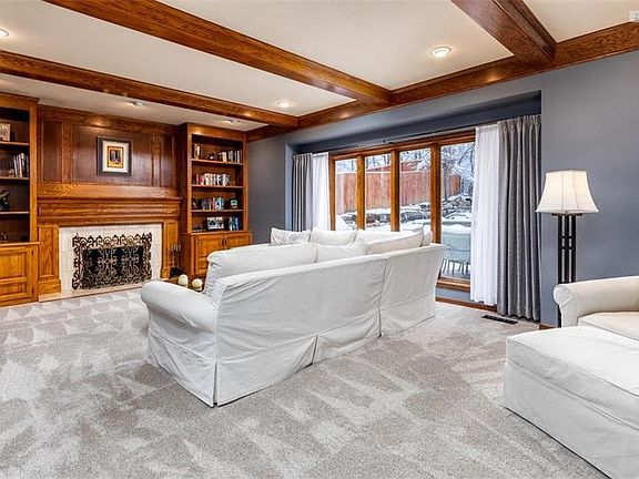 Main level family room with built ins and glorious wooden beams