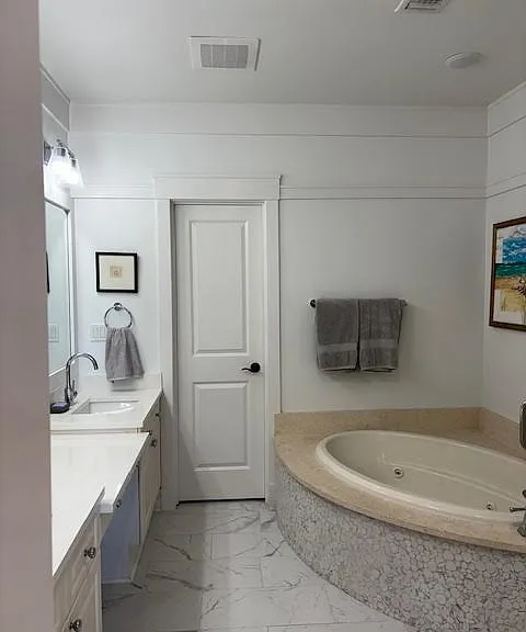 Master bath, double sink, jetted tub, and shower