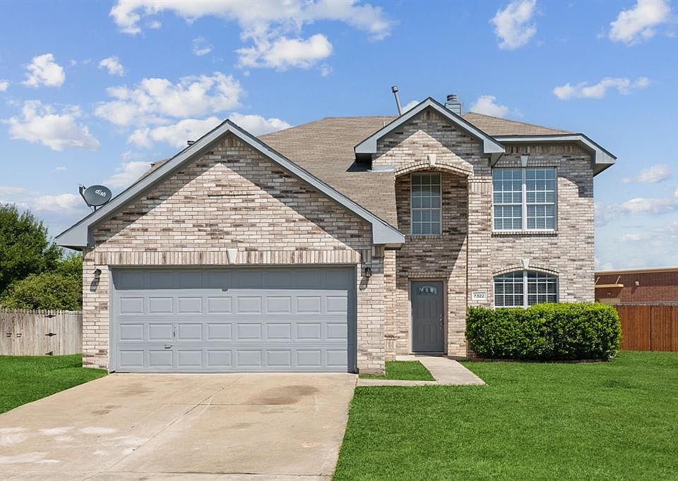 Front of property with a garage and a front yard