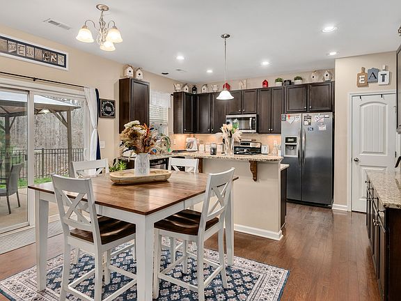 Kitchen with granite counters, breakfast nook, and outdoor patio