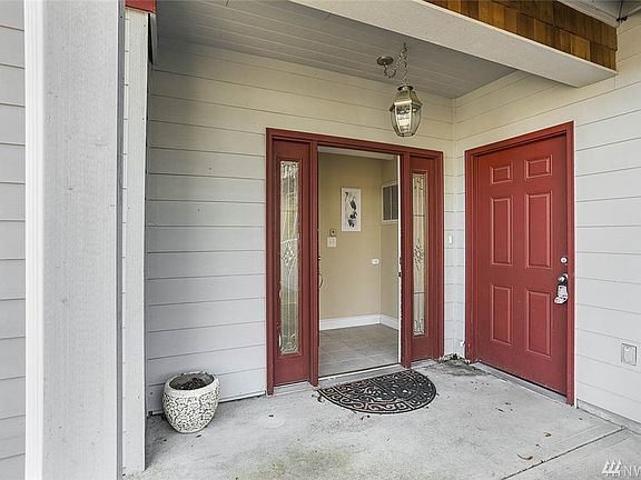 Guests are welcomed with this covered porch. Door to the right is to access the garage.