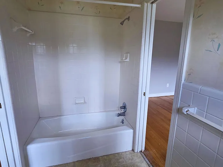 Unwind in a spotless, spacious bathtub designed for comfort.