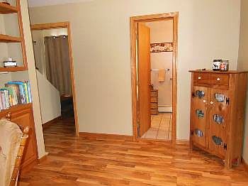 The bathroom is located off from the living area and just before the stairway to the upstairs bedroom.
