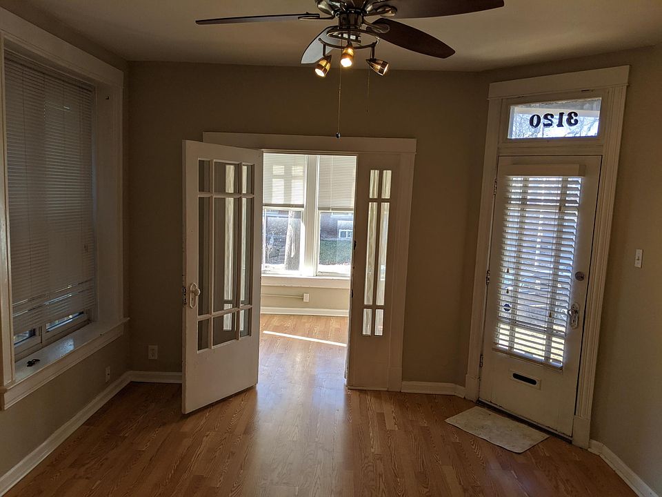 Standing in bedroom doorway looking towards the living room, front door and sunroom