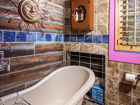 MASTER BATHROOM WITH OLD FASHIONED CLAW TUB AND AND ITALIAN CUSTOM MADE TILE -- ALSO COMES WITH PORCELIN SINK AND TOILET