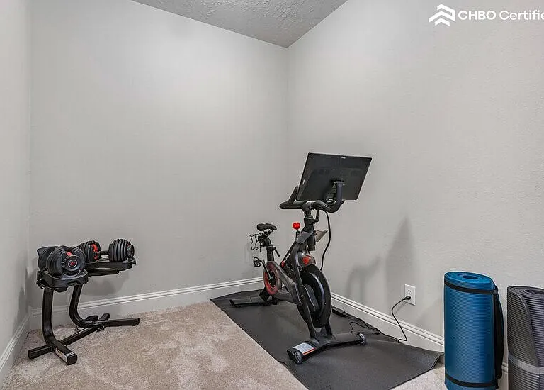 Home gym with peloton and weights